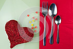 Valentines day table setting with plate red ribbon and hearts