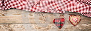 Valentines day. Top view of fabric hearts, wooden background, banner