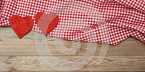 Valentines day. Top view of red fabric hearts, wooden background