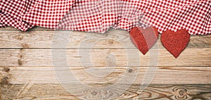 Valentines day. Top view of red fabric hearts, wooden background