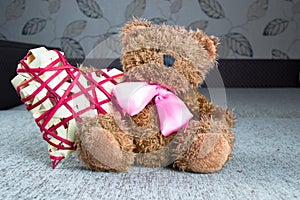 Valentines Teddy Bear with red hearts sitting alone