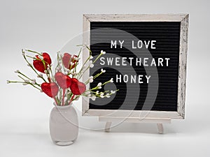 Valentineâ€™s Hearts in a Vase with Words, My Love, Sweetheart and Honey on Letter Board with White Background