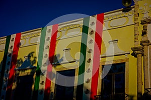 VALLADOLID, MEXICO - NOVEMBER 12, 2017: Outdoor view of a building with a mexican flag hanging in the facade in a