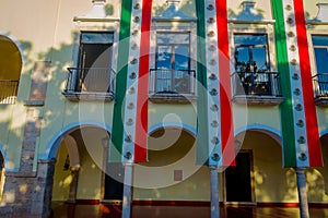 VALLADOLID, MEXICO - NOVEMBER 12, 2017: Outdoor view of a building with a mexican flag hanging in the facade in a