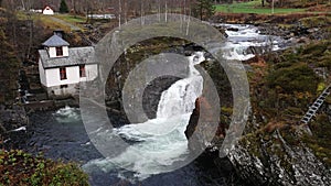Valldola foss waterfall in river on Trollstigen route in snow in Norway