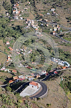 VALLE GRAN REY, LA GOMERA, SPAIN: View of the valley with terraced fields and mountains. Winding road and the church of San Antoni
