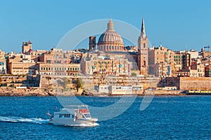 Valletta citiscape with bay cruise boat, Malta