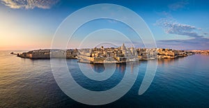 Valletta, Malta - Aerial panoramic skyline of Valletta at sunrise with Our Lady of Mount Carmel church