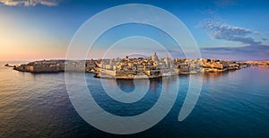 Valletta, Malta - Aerial panoramic skyline of Valletta at sunrise with Our Lady of Mount Carmel church