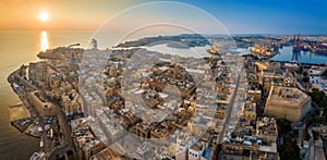 Valletta, Malta - Aerial panoramic skyline view of Valletta at sunrise with cruise ship entering at Grand Harbor