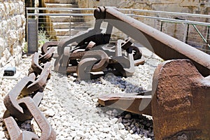 Valletta, Malta, August 2019. Ship anchor and fragment of an anchor chain in a military museum.