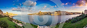 Valletta, Malta - Panoramic skyline view of the ancient city of Valletta and Sliema at sunrise