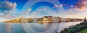 Valletta, Malta - Panoramic skyline view of the ancient city of Valletta and Sliema at sunrise shot from Manoel island at spring