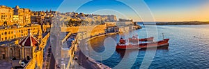 Valletta, Malta - Panoramic skyline view of Valletta and the Grand Harbour at sunrise