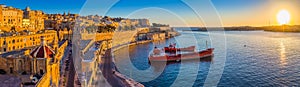 Valletta, Malta - Panoramic skyline view of Valletta and the Grand Harbour at sunrise