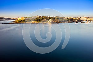 Valletta, Malta - Summer sunrise view with Manoel island, Valletta and Sliema with sailing boats