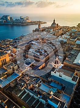Valletta, Malta - Sunrise above Valletta with Our Lady of Mount Carmel church and St.Paul`s Cathedral