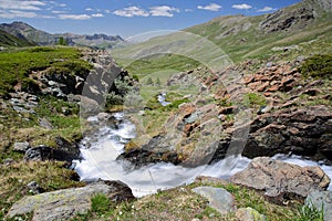 The valley Aigle Blanche close to Saint Veran viewed from the path leading to Refuge de la Blanche, with a torrent photo