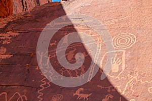 Valley of Fire - Close up view of Native American rock art (Petroglyphs) on red Aztek sandstone wall of Atlatl rock, Nevada