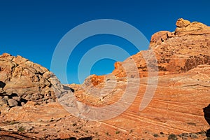 Valley of Fire - Panoramic view of red and orange Aztec Sandstone Rock formations and desert vegetation, Nevada