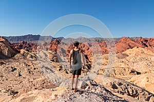 Valley of Fire - Rear view of man at Silica Dome viewpoint overlooking the Valley of Fire State Park in Mojave desert, Nevada, USA