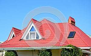 Valley and gable roofing construction with attic windows, rain gutter, waterproofing. Roof gutter system, skylight window on attic