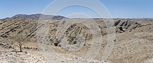 valley with layers and crumble of basalt rocks in Naukluft desert, near Kriess se rus, Namibia