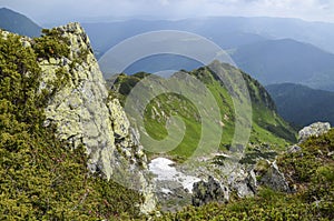 Valley among majestic rugged mountain hills and peaks covered in green lush grass Carpathian mountains