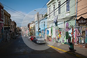 City street in Barrio Bellavista district with colorful houses and walls decorated with graffiti