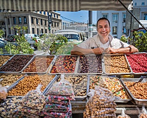 VALPARAISO, CHILE - Nov 19 - Happy vendor selling sweets on the streets of Valparaiso in Chile on Nov 19, 2014