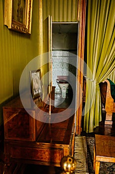 Valtice, Southern Moravia, Czech Republic, 04 July 2021: Castle interior with baroque wooden carved furniture, green bedroom with