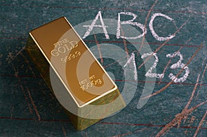 Value of Education Concept Gold Ingot on Old Schoolboard