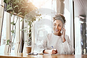 The value of an idea lies in the using of it. Attractive business woman working at desk in modern office.