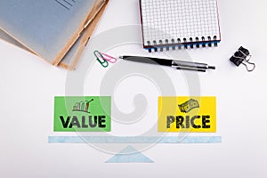 Value and Price Balance concept. Paper scale on a white table