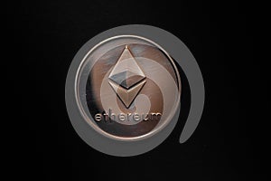 valueable shining gold silver ether coin from cryptocurrency middle on black