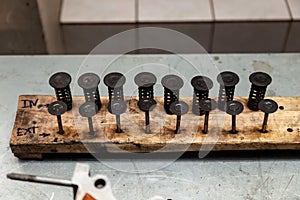 Valve of a car engine with carbon deposits and in oil with springs extracted from a vehicle on a workbench during a major overhaul