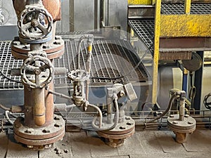 Valves and other safety equipment on an old steam boiler. Extensive wear, corrosion and contamination of the equipment and the