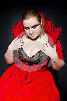 Vampire in red dress with top collar