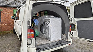 A van filled with house clearance auction items ready to be removed photo