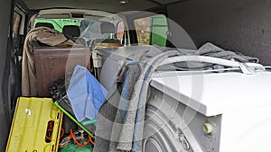 A van filled with house clearance household garage appliances ready to transport
