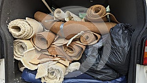 A van full of house clearance rolls of carpet and underlay