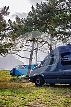 Van on the grass parking lot close to the beach. Campervan parking.