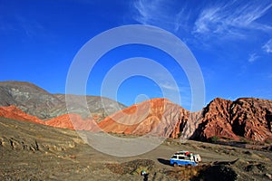 Van on the hill of seven colors, cerro de los siete colores, at Purmamarca, Jujuy, Argentina