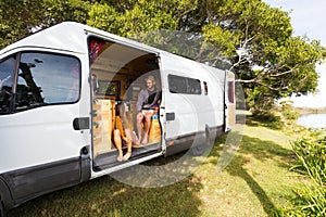 Van life couple in bohemian camper van at a scenic Australian location