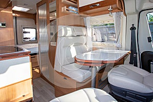 Van modern white table and seat interior in luxury camper or motorhome on rv vanlife