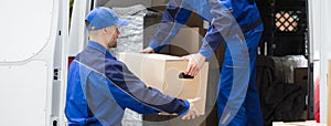 Van Movers Unloading Cardboard Boxes