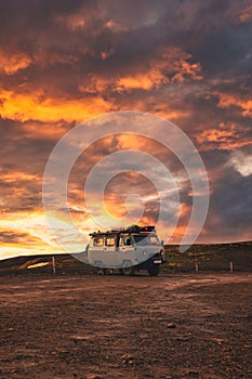 Van parked with sunset sky on top of mountain in Icelandic Highlands on summer at Iceland