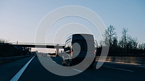 Van silhouette driving at dusk on European highway German autoba