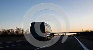 Van silhouette driving at dusk on European highway German autoba