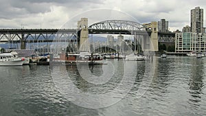 Vancouver BC Canada with Cambie Bridge Buildings Moving Clouds and Water Transportation along English Bay